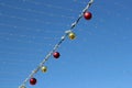 Multi-colored glass balls and LED garlands adorn the sunny blue sky of Christmas Israel Royalty Free Stock Photo