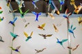 Multi-colored glass birds hang on strings. Royalty Free Stock Photo