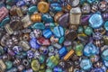 A multi-colored glass gems with holes lie in a heap Royalty Free Stock Photo