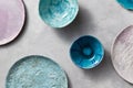 Multi-colored glay vintage handmade dishes. Flat lay. Set of porcelain blue bowls on a gray concrete table. Royalty Free Stock Photo