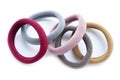 Multi-colored hair ties on white background on white background. Top view. Multicolored elastics,