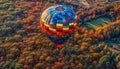Multi colored hot air balloon gliding high above vibrant mountain range generated by AI