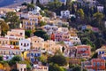 Multi-colored houses on the shore of the ancient harbor on the island of Symi. Coast of the Aegean. Greece