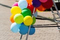 Multi-colored inflatable balls on a metal stepladder. Close-up