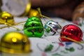 Multi-colored jingle bells on a light background. Selective focus. Close-up Royalty Free Stock Photo