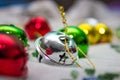 Multi-colored jingle bells on a light background. Selective focus. Close-up Royalty Free Stock Photo