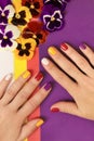 Multi-colored juicy manicure on short female nails Royalty Free Stock Photo