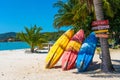 Multi-colored kayaks on a tropical sandy beach. Kayak rental. Tourist entertainment Royalty Free Stock Photo