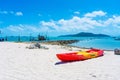 Multi-colored kayaks on a tropical sandy beach. Kayak rental. Tourist entertainment Royalty Free Stock Photo