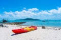 Multi-colored kayaks on a tropical sandy beach. Kayak rental. Tourist entertainment Royalty Free Stock Photo