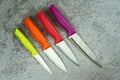 Multi-colored kitchen knives: red, burgundy, orange, yellow