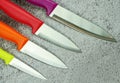 Multi-colored kitchen knives: red, burgundy, orange, yellow