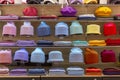 Multi-colored knitted hats on the shelves in the store. Fashion, style and comfort. Front view Royalty Free Stock Photo