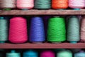 Multi-colored large spools of thread in a row. Spools of colored thread Royalty Free Stock Photo