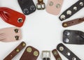Multi-colored leather belts and bracelets with rivets on a white background lie in the shape of a circle. handmade craft Royalty Free Stock Photo