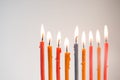 Multi-colored lighted candles on chanukiah closeup