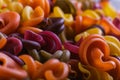 Multi-colored macaroni of an unusual form with natural vegetable dyes. Background macro close up