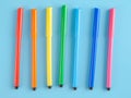 Multi-colored markers bright colorful on a blue background, children`s markers Royalty Free Stock Photo