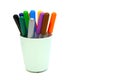 Multi colored markers in plastic cup isolated on a white background. Materials for children`s creativity Royalty Free Stock Photo