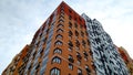 Multi-colored modern multi-storey residential building and multi-apartment panel house with Windows and balconies Royalty Free Stock Photo