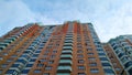 Multi-colored modern multi-storey residential building and multi-apartment panel house with Windows and balconies Royalty Free Stock Photo