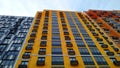 Multi-colored modern multi-storey residential building and multi-apartment panel house with Windows and balconies