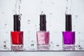 Multi-colored nail polish bottles in water spray, manicure Royalty Free Stock Photo