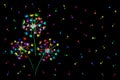 Multi-colored neon dandelions with scattered fluffs on a black background