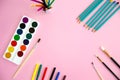 Multi-colored objects for drawing and creativity for children lie on a pink background. Bright watercolor paints, pencils, brushes Royalty Free Stock Photo