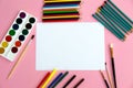 Multi-colored objects for drawing and creativity for children lie on a pink background. Bright watercolor paints, pencils, brushes Royalty Free Stock Photo