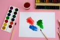 Multi-colored objects for drawing and creativity for children lie on a pink background. Bright watercolor paints, pencils, brushes Royalty Free Stock Photo