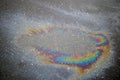 Multi colored oil spill on asphalt road, background Royalty Free Stock Photo