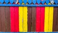 A multi-colored painted wooden fence. Background for advertising and photos. Wooden boards painted with paint of different colors