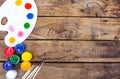Multi-colored paints,brushes palette, brush,lie on a wooden background top view Royalty Free Stock Photo