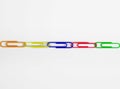 Multi colored paper clips in row Royalty Free Stock Photo