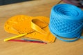 Multi-colored parts, straps, crochet hooks and bright blue yarn for making handmade knitted bags. Selective soft focus Royalty Free Stock Photo