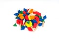 Multi Colored pattern blocks on a white wooden background.Isolate