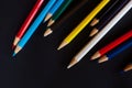 Multi-colored pencils for drawing on a black background, a set of pencils for the artist