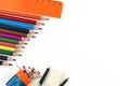 Multi-colored pencils, eraser, ruler, sharpener and compasses on a white background Royalty Free Stock Photo