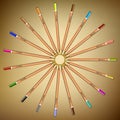 Multi-colored pencils laid out in a circle on the paper.Vector Royalty Free Stock Photo