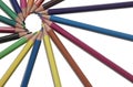 Multi-colored pencils lying on a white isolated background in a circle close-up.