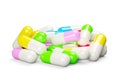 Multi colored pill capsules heap over white background, medical treatment, pharmaceutical or medication concept