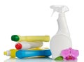Multi-colored plastic bottles with liquid detergent and orchid isolated. Royalty Free Stock Photo