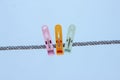 Multi colored plastic clothes clips on the rope. Royalty Free Stock Photo