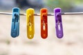 Multi colored plastic clothes clips on the wire on nature background. Royalty Free Stock Photo