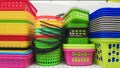 Multi-colored plastic containers of different shapes and sizes with and without lids, stacked in a pile on a store window. Sale of Royalty Free Stock Photo