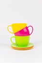 multi-colored plastic cups and plates on a white background kitchen set Royalty Free Stock Photo