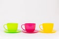 multi-colored plastic cups and plates on a white background kitchen set Royalty Free Stock Photo