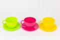 multi-colored plastic cups and plates on a white background kitchen set Royalty Free Stock Photo