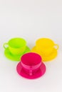 multi-colored plastic cups and plates on a white background kitchen set Royalty Free Stock Photo